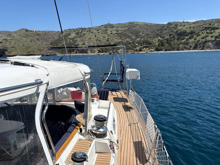 2.0 Impulsive Yacht Photos Pics Sailing yacht Beneteau 57, 2005 model, anchored in a scenic coastal bay.