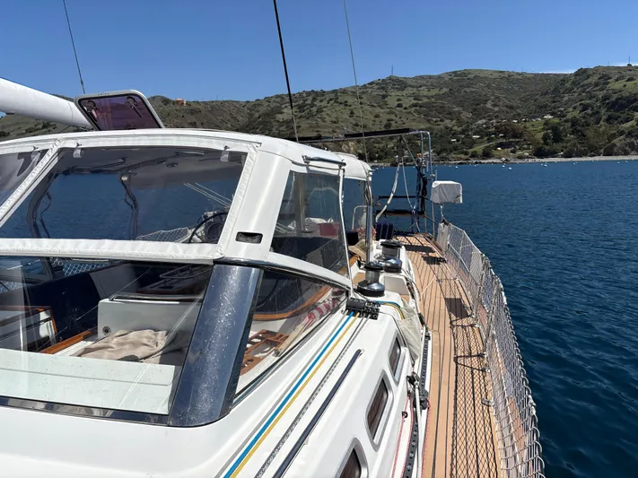 2.0 Impulsive Yacht Photos Pics 2005 Beneteau 57 yacht on calm water, scenic coastal backdrop.