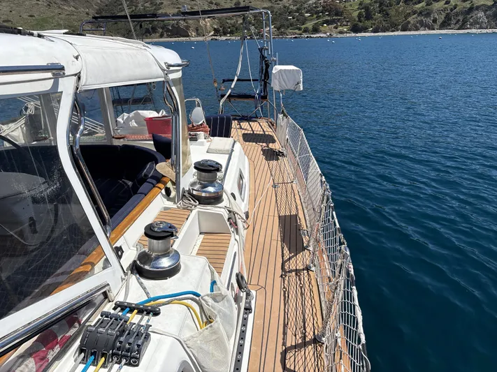 2.0 Impulsive Yacht Photos Pics Beneteau 57 sailboat deck, 2005 model, with ocean view and clear skies.