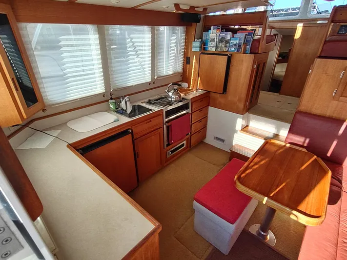 Santosha Yacht Photos Pics Interior of 2006 Nordic Tug 32, featuring a cozy kitchen and dining area.