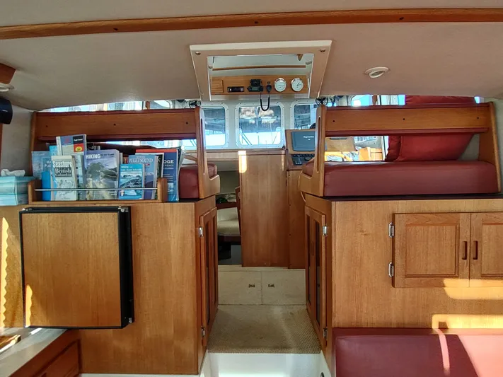 Santosha Yacht Photos Pics Interior of 2006 Nordic Tug 32, featuring wood cabinetry and seating.