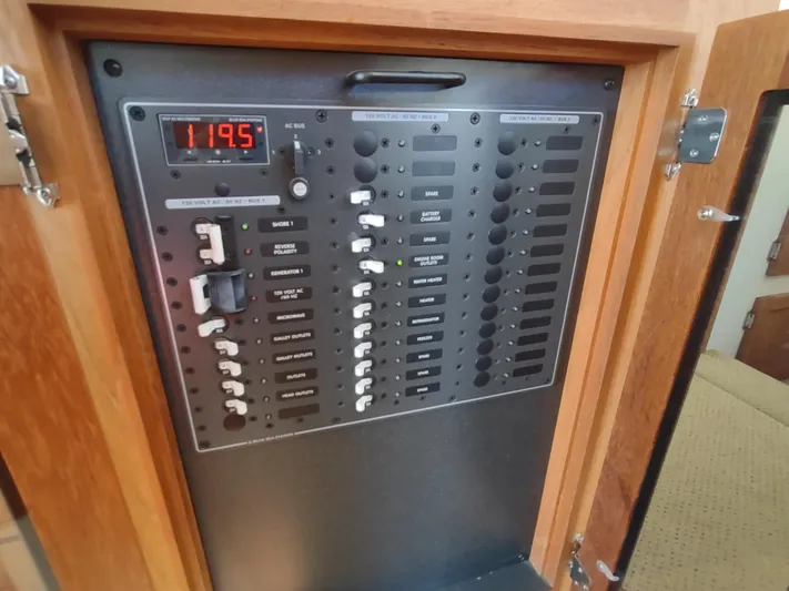 Santosha Yacht Photos Pics Electrical panel of a 2006 Nordic Tug 32 boat, featuring switches and voltage display.