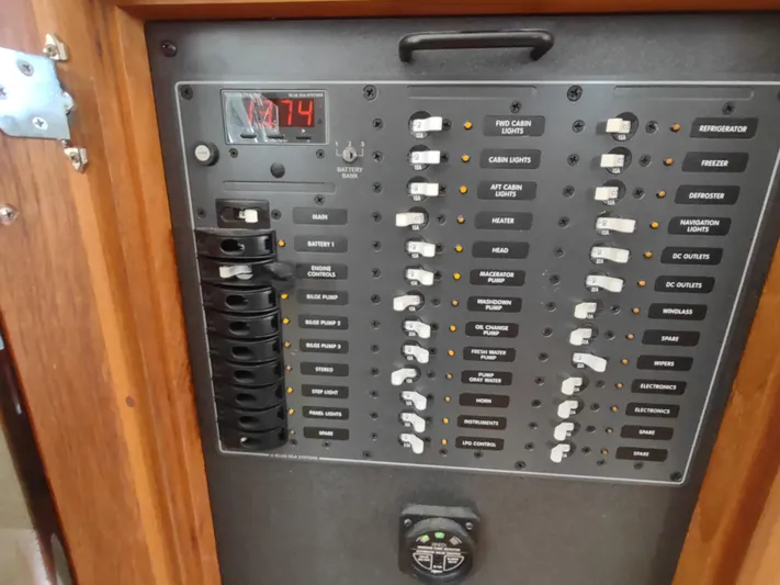 Santosha Yacht Photos Pics Electrical panel of a 2006 Nordic Tug 32 boat, featuring various switches and a digital display.