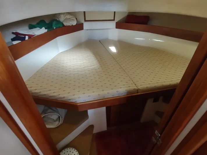 Santosha Yacht Photos Pics 2006 Nordic Tug 32 interior cabin with a cozy bed and wooden accents.