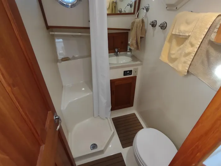Santosha Yacht Photos Pics Bathroom interior of 2006 Nordic Tug 32 with shower, sink, and toilet.