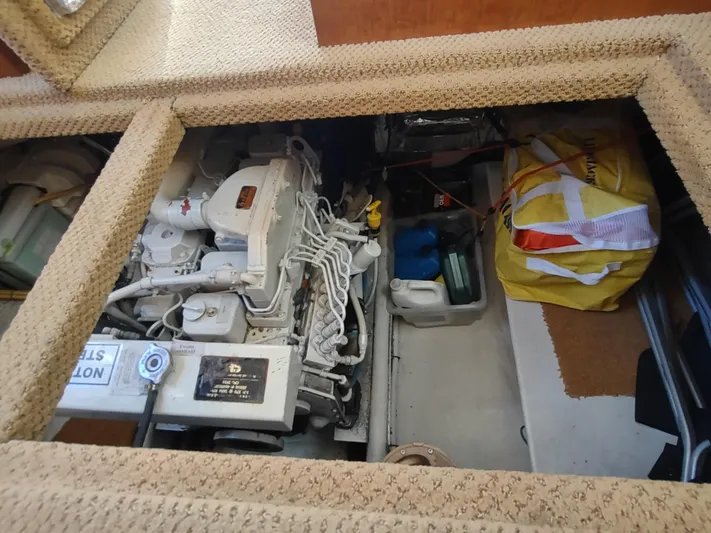 Santosha Yacht Photos Pics Engine compartment of a 2006 Nordic Tug 32, showing engine and storage area.