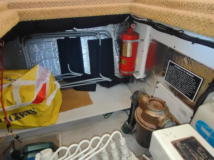 Santosha Yacht Photos Pics Engine room of 2006 Nordic Tug 32 with fire extinguisher and equipment.