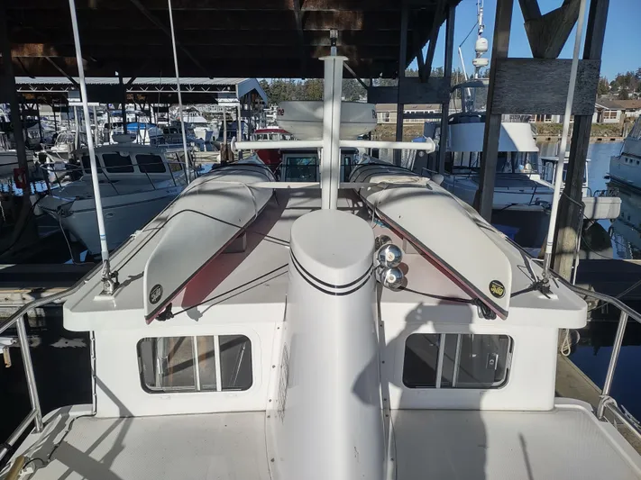 Santosha Yacht Photos Pics 2006 Nordic Tug 32 docked in a marina, showcasing its deck and cabin features.