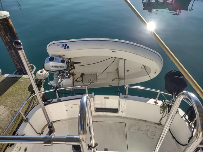 Santosha Yacht Photos Pics 2006 Nordic Tug 32 with dinghy and Honda outboard motor at dock.