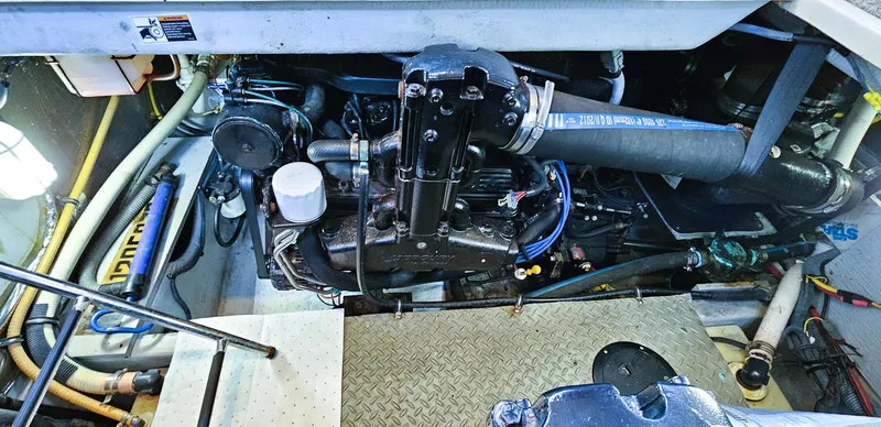  Yacht Photos Pics Engine compartment of a 2007 Meridian 341 Sedan boat, showcasing mechanical components and hoses.