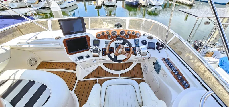  Yacht Photos Pics 2007 Meridian 341 Sedan yacht cockpit with steering wheel, navigation screens, and marina view.