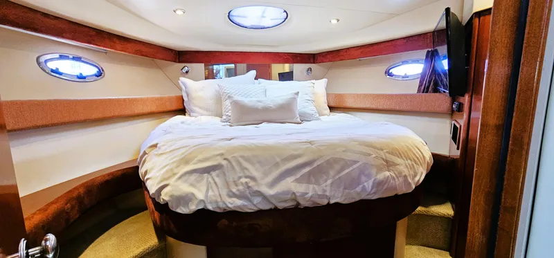  Yacht Photos Pics Luxurious bedroom interior of 2007 Meridian 341 Sedan yacht with cozy bedding.