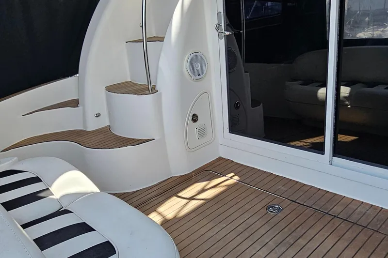  Yacht Photos Pics 2007 Meridian 341 Sedan yacht interior with striped seating and wooden flooring.