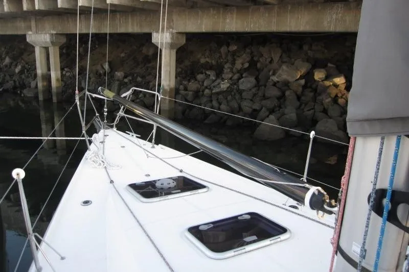 Rush Yacht Photos Pics 2018 Jeanneau Sun Fast 3600 sailboat deck near rocky shoreline.