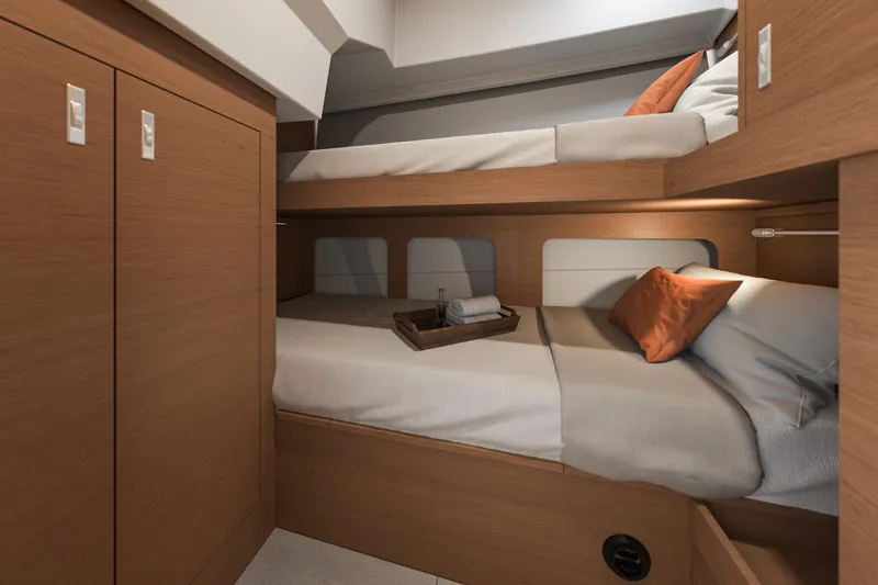  Yacht Photos Pics Interior of 2026 Beneteau Swift Trawler 37 Fly with cozy bunk beds and wooden cabinetry.