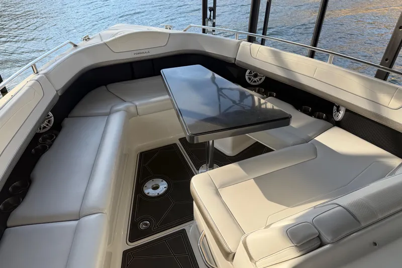  Yacht Photos Pics 2021 Formula 350 Crossover Bowrider I/O interior with seating and table, docked by water.