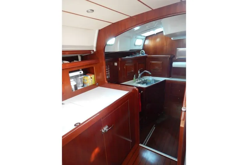  Yacht Photos Pics Interior of 2004 Beneteau 50 yacht, featuring elegant wood cabinetry and modern kitchen amenities.