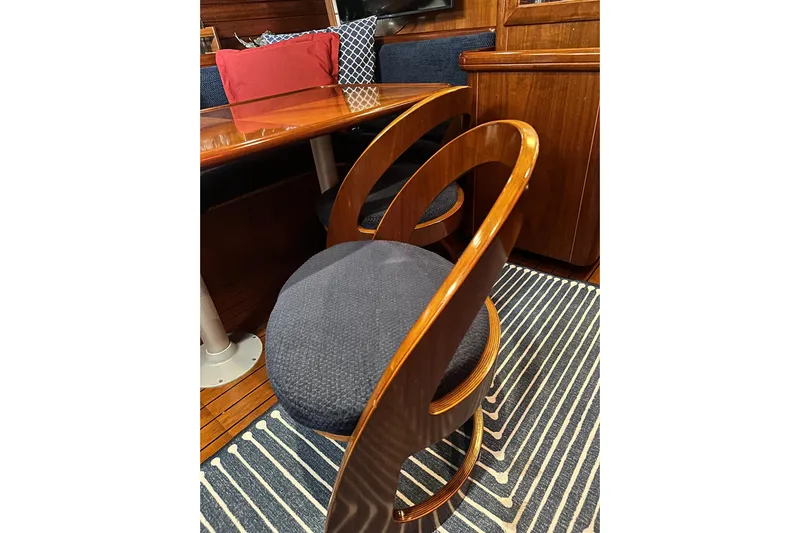  Yacht Photos Pics Elegant interior of 2004 Beneteau 50 yacht with stylish wooden chair and table.