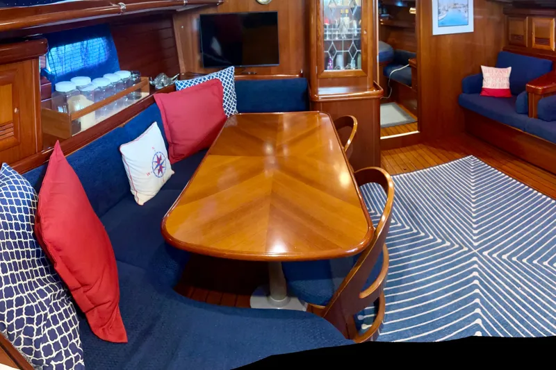  Yacht Photos Pics Luxurious interior of 2004 Beneteau 50 yacht with elegant wood finish and cozy seating.