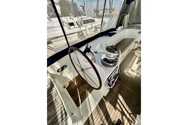  Yacht Photos Pics Cockpit of 2004 Beneteau 50 sailboat with wooden deck and steering wheel.