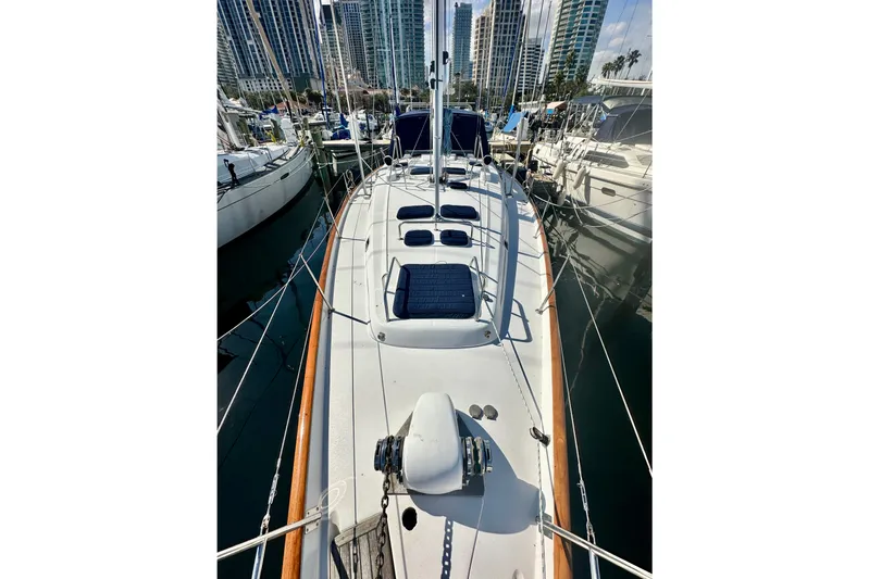  Yacht Photos Pics 2004 Beneteau 50 sailboat docked in marina, surrounded by other boats and cityscape.