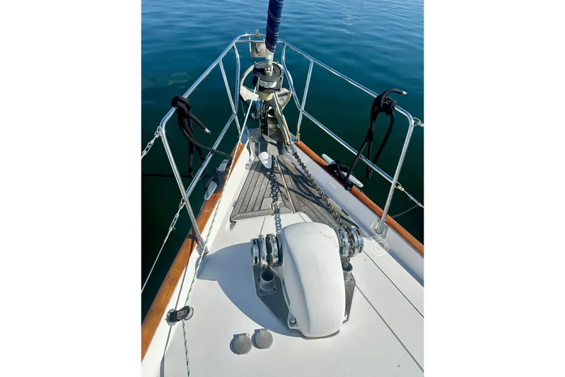  Yacht Photos Pics Bow of a 2004 Beneteau 50 sailboat with anchor and railing.