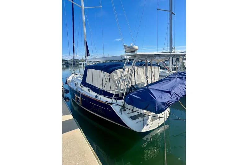  Yacht Photos Pics 2004 Beneteau 50 sailboat docked, featuring blue covers and sleek design.