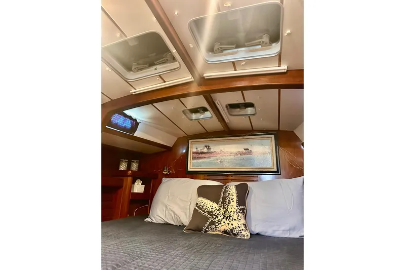  Yacht Photos Pics Luxurious cabin interior of 2004 Beneteau 50 yacht with cozy bedding and decor.