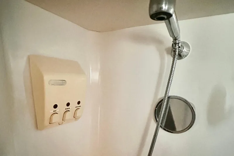  Yacht Photos Pics Shower area in 2004 Beneteau 50 yacht with dispenser and handheld showerhead.