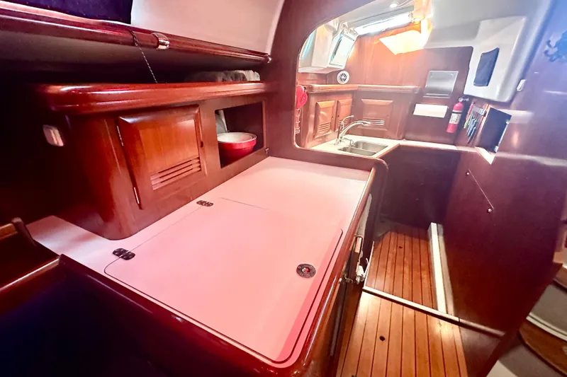  Yacht Photos Pics 2004 Beneteau 50 yacht kitchen with wooden cabinetry and modern amenities.