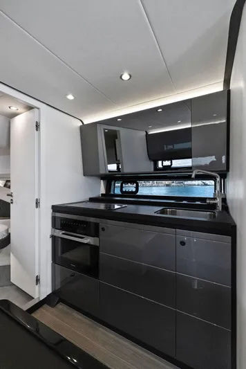 Second Chances Yacht Photos Pics Modern kitchen interior of 2022 Azimut Verve 47 yacht, featuring sleek cabinetry and appliances.