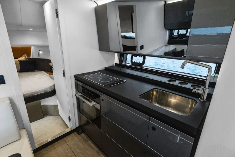 Second Chances Yacht Photos Pics Luxurious interior of 2022 Azimut Verve 47 yacht with modern kitchen and cozy bedroom.
