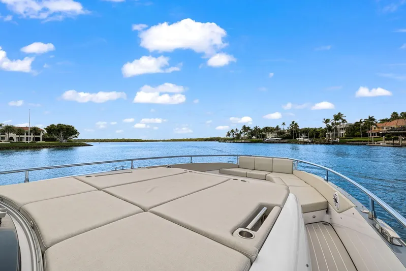 Second Chances Yacht Photos Pics Azimut Verve 47 yacht, 2022 model, cruising on a serene waterway under a clear blue sky.