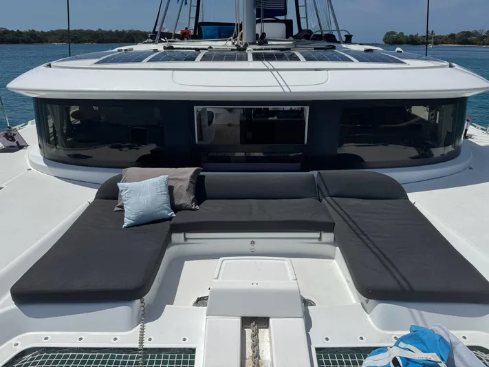 Primrose Yacht Photos Pics 2023 Lagoon 46 catamaran with spacious deck seating and scenic ocean backdrop.