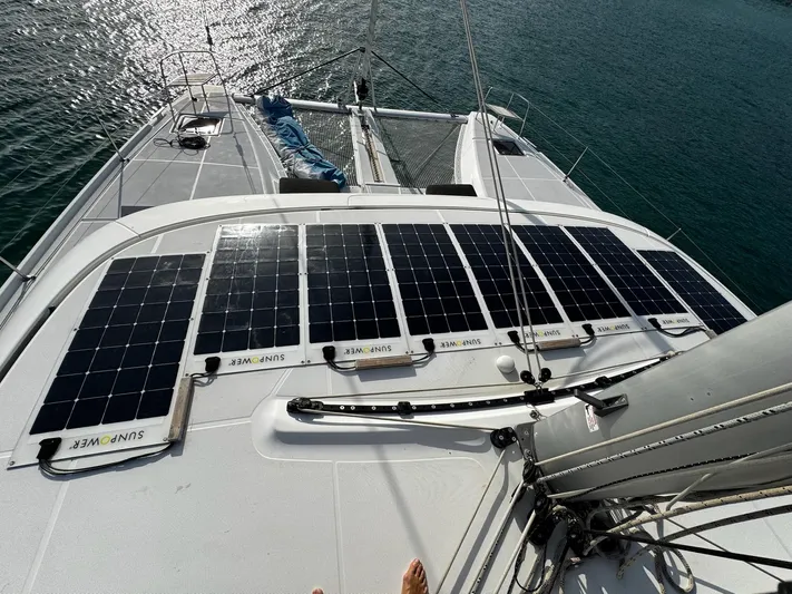 Primrose Yacht Photos Pics 2023 Lagoon 46 catamaran with solar panels on deck, sailing on calm waters.