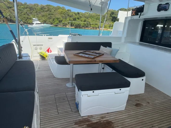 Primrose Yacht Photos Pics 2023 Lagoon 46 yacht deck with seating area, table, and ocean view.