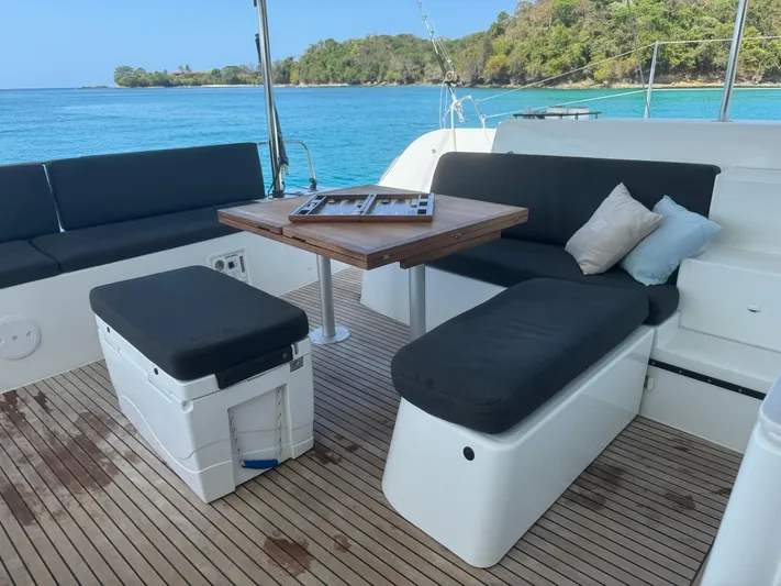 Primrose Yacht Photos Pics Luxurious Lagoon 46 yacht deck with seating, table, and ocean view, 2023 model.