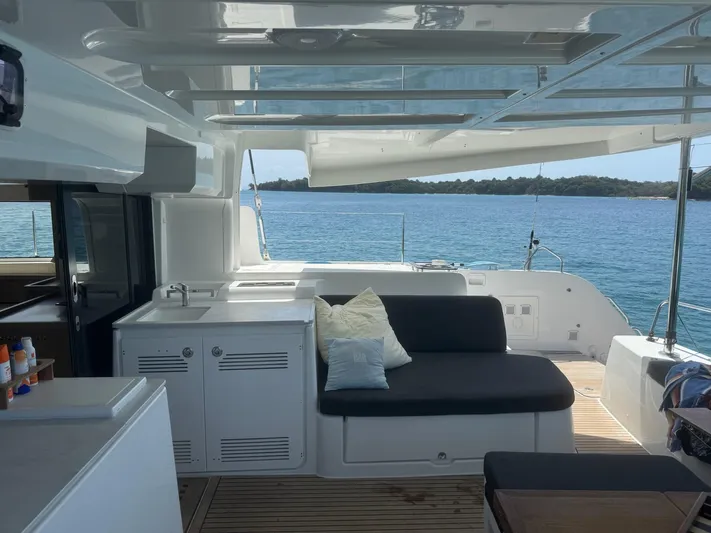 Primrose Yacht Photos Pics 2023 Lagoon 46 yacht interior with seating, ocean view, and modern design.