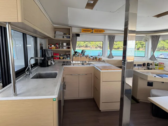 Primrose Yacht Photos Pics Modern kitchen interior of 2023 Lagoon 46 catamaran with scenic ocean view.