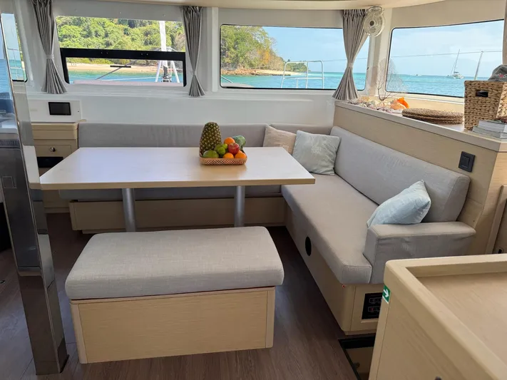 Primrose Yacht Photos Pics Interior of 2023 Lagoon 46 catamaran with dining area and ocean view.