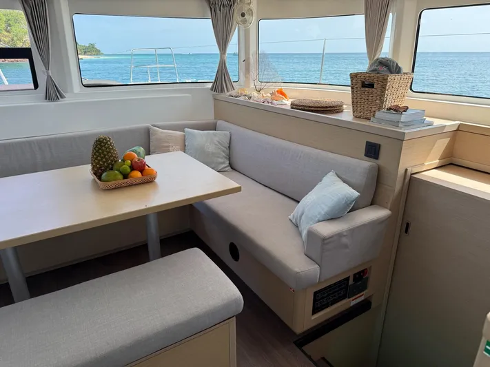 Primrose Yacht Photos Pics Interior of 2023 Lagoon 46 catamaran with cozy seating and ocean view.