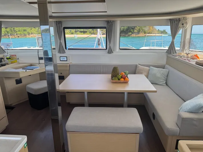 Primrose Yacht Photos Pics Modern interior of 2023 Lagoon 46 catamaran with dining area and ocean view.