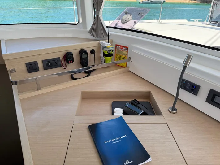 Primrose Yacht Photos Pics Interior of 2023 Lagoon 46 yacht with navigation tools and a journal on the desk.