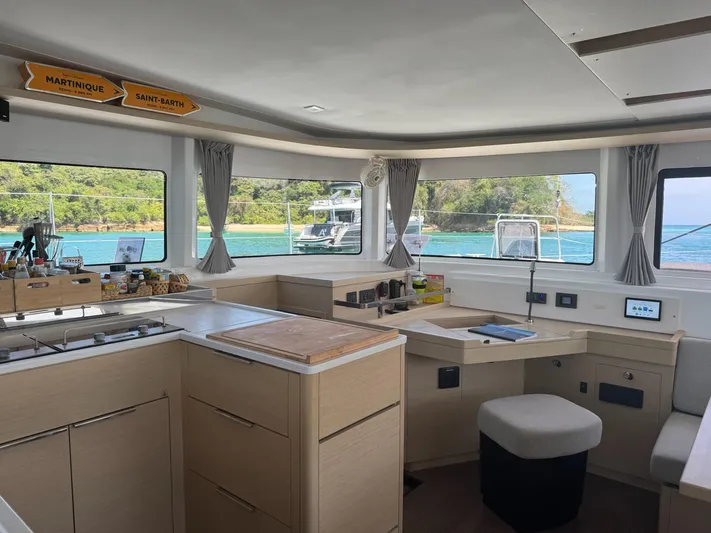 Primrose Yacht Photos Pics Interior of 2023 Lagoon 46 catamaran with modern kitchen and scenic ocean view.
