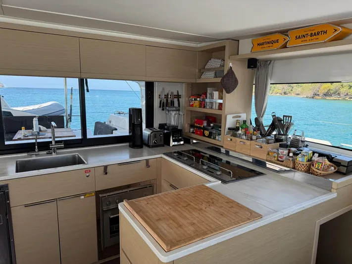 Primrose Yacht Photos Pics Modern kitchen interior on 2023 Lagoon 46 yacht with ocean view.