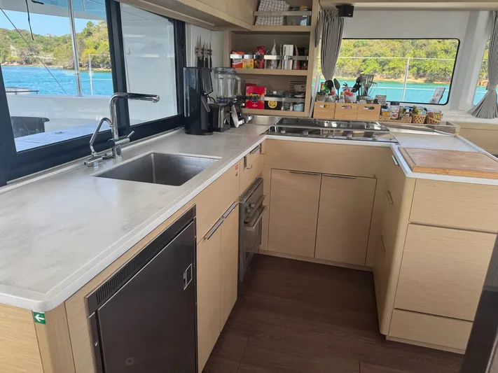 Primrose Yacht Photos Pics Modern kitchen interior of 2023 Lagoon 46 yacht with ocean view.