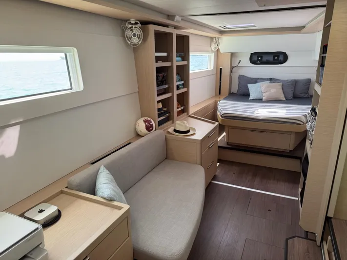 Primrose Yacht Photos Pics Interior of 2023 Lagoon 46 yacht, featuring a cozy bedroom and seating area.