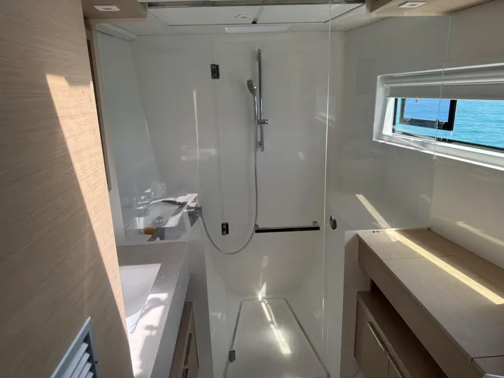 Primrose Yacht Photos Pics Modern bathroom in 2023 Lagoon 46 yacht with shower and window view.