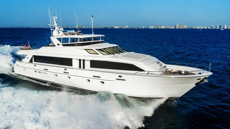 Magic Yacht Photos Pics Hatteras 100 Motor Yacht 2005 cruising on open sea, clear blue sky.