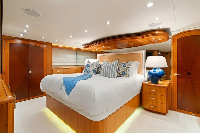 Magic Yacht Photos Pics Luxurious bedroom interior of 2005 Hatteras 100 Motor Yacht with elegant wood finishes.